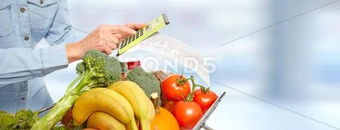 Woman hands with grocery receipt and calculator. Stock Photos