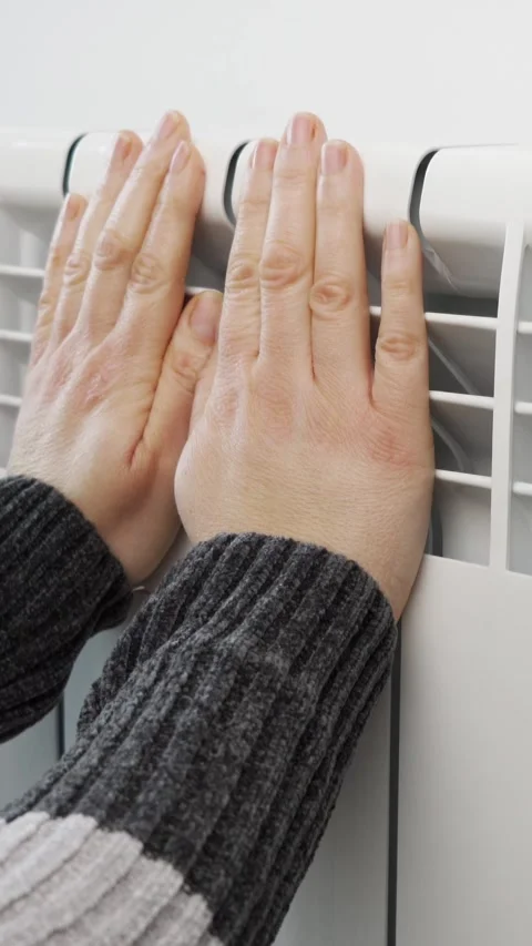 Woman hands heating touching central radiator thermostat save energy power Видео 335240867