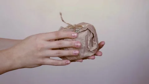 Woman hands hold creative present in recycled zero waste craft paper gift wrap Stock Footage 165407261