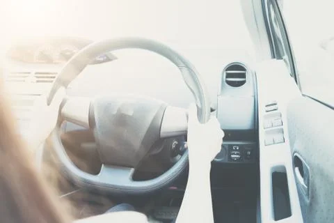 Woman hands holding on black steering wheel while driving a car, Hands of fem Stock Photos