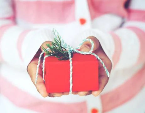 Woman hands holding Christmas handmade gift box or new year present with snow ba Stock Photos