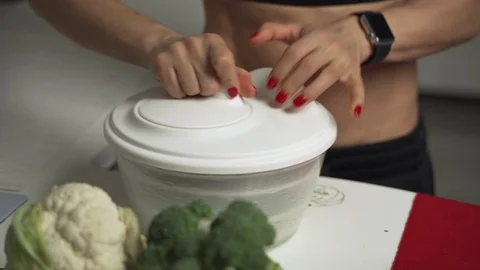 Woman hands with knife cutting broccoli. Close up fresh vegetables on kitchen Stock Footage 99013853