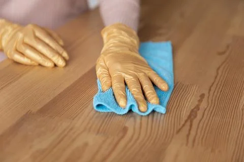 Woman hands in latex gloves rub wooden surface with cloth Stock Photos