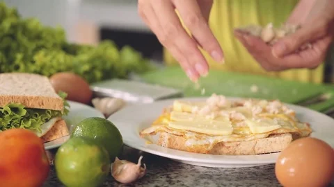 Woman hands making sandwich with egg, cheese, chicken and green salad Stock Footage