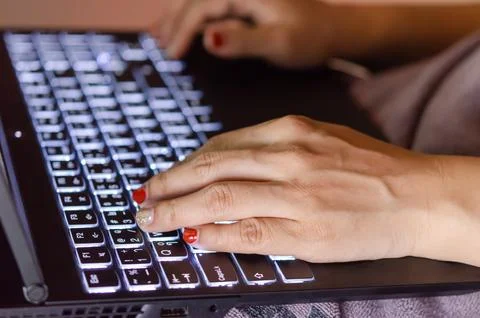 Woman hands on a notebook computer. Stock Photos