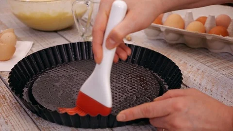Woman hands oiling the baking pan preparing to make a cake 動画素材 101863485