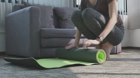 Woman hands is rolling up exercise mat and preparing to doing yoga or the end Stock Footage 154760064