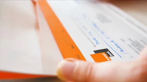 Woman hands signing a banking cheque in the check book of Orange Bank Stock Footage