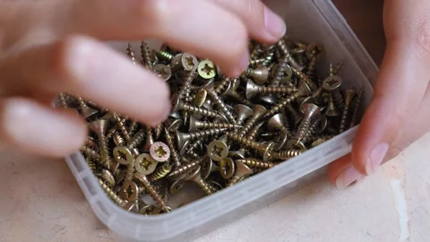 Woman hands sorting through a box of screws Stock Footage 323950191