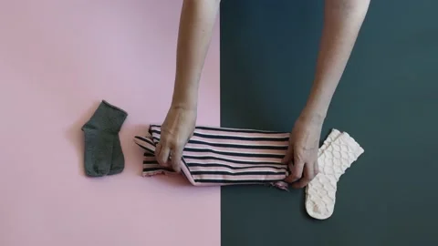 Woman hands stack kid clothes Stock Footage 240097668