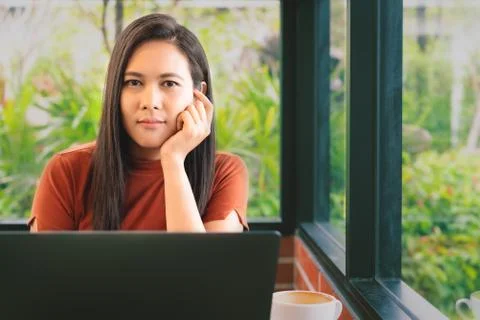 Woman hands thinking while working on laptop look at camera. Woman working at Stock Photos