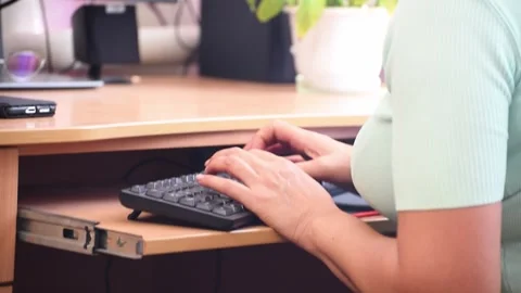 Woman hands typing computer keyboard. Distance work. Woman in her late 45 works Stock Footage 250171940