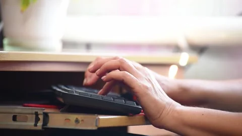Woman hands typing computer keyboard. Distance work. Woman in her late 45 works Stock Footage 251459500