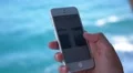 Woman Hands Using Cell Phone against the Sea. Slow Motion. HD Footage