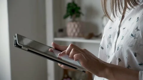 Woman hands using digital tablet close up at home side view Video stock 220225078