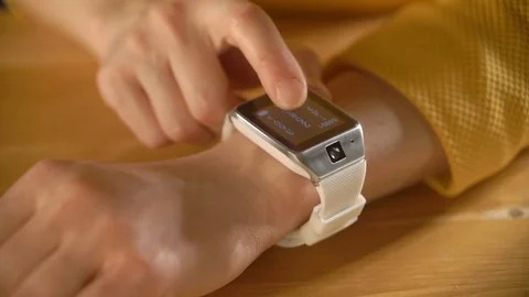 Woman hands using her smartwatch touchscreen Stock Footage 69970076