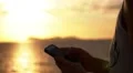 Woman Hands Using iPhone at Sunset in Slow Motion HD Footage