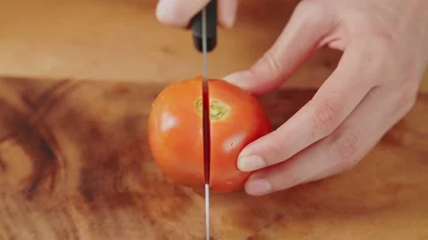 Woman hands using kitchen knife cutting fresh tomato on wooden. 스톡 동영상 153970097