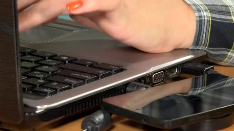 Woman hands using laptop computer and phone charge on wireless charger. Closeup Video stock 91874471