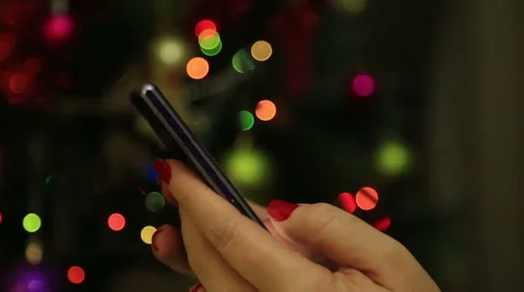 Woman hands using mobile smart phone with colorful light bokeh background 4 Stock Footage 57631900