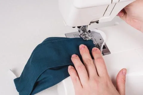 Woman hands using the sewing machine to sew the face mask during.the coronavi Stock Photos