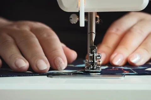 Woman hands using the sewing machine at home Stock Photos