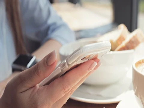 Woman Hands Using Smart Phone in a Cafe, Close Up. 4K SLOW MOTION DCi Dolly Shot 動画素材 79365305