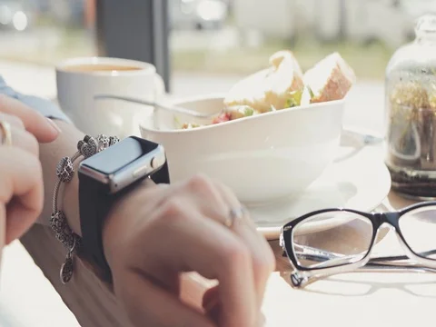 Woman Hands Using Smart Watch in a Cafe, Close Up. 4K SLOW MOTION DCi Vidéo 79365510