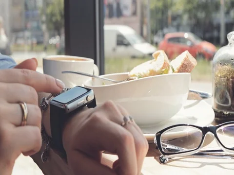Woman Hands Using Smart Watch in a Cafe, Close Up. 4K SLOW MOTION DCi Stock Footage 79365679