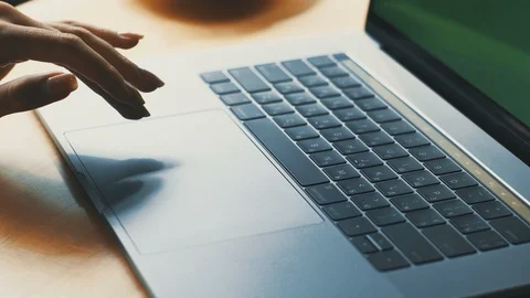 Woman hands using touchpad on computer at wooden desk Stock Footage 117127885