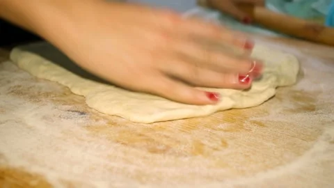 Woman hands view while baking homemade pizza with rollingpin in kitchen,lockdown Stock Footage 142565493