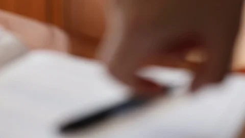 Woman hands write text on the paper. Blurred motion background. Stock Footage 128223938