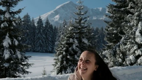 Woman happily throws hands snow in the woods on against mountains. Stock Footage 73071253