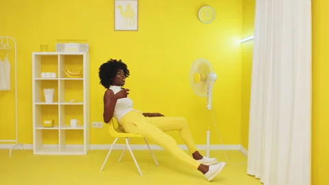 Woman Has Fun In Yellow Room Stock Footage 149737726