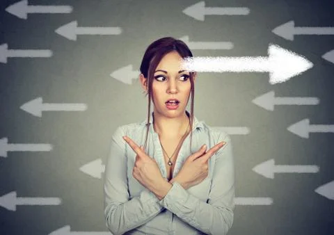 Woman has second thought perplexed pointing fingers in different direction Stock Photos