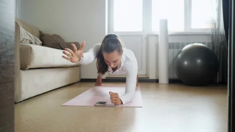 Woman has training watching tutorial on phone in room Stock Footage 136870174