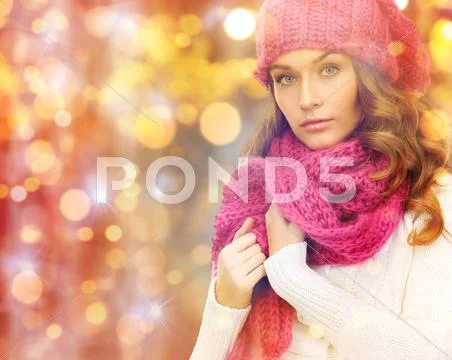 Woman in hat and scarf over christmas lights Stock Photos
