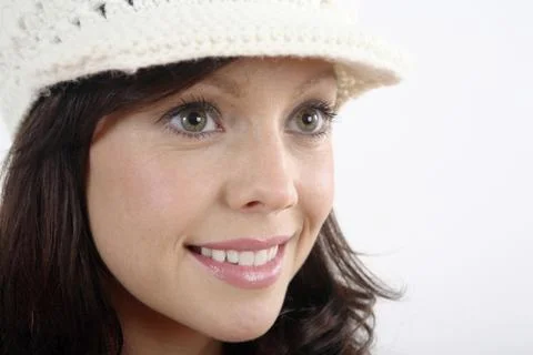 Woman in hat smiling while looking away Stock Photos