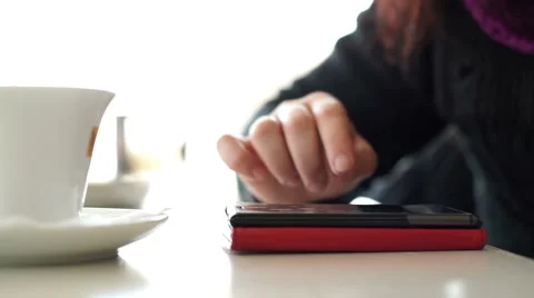 Woman having coffee while surfing internet with smartphone Stock Footage 45771846