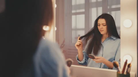 Woman having difficulty brushing her tangled hair, dryness, split ends problem Stock Footage 233116839