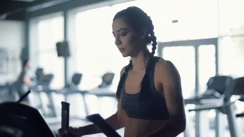 Woman having exercise with cross trainer Stock Footage