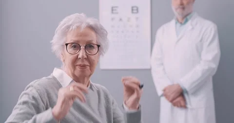 Woman having an eye test and wearing new glasses Stock Footage 297849040