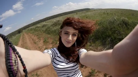 Woman having fun with camera on field Stock Footage 76588085