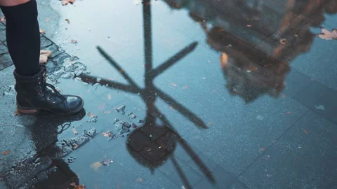 Woman having fun splasing water at rainy wet weather. female feet walking on Stock Footage 135357643