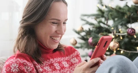 Woman having fun while texting on mobile phone Stock Footage 129423454