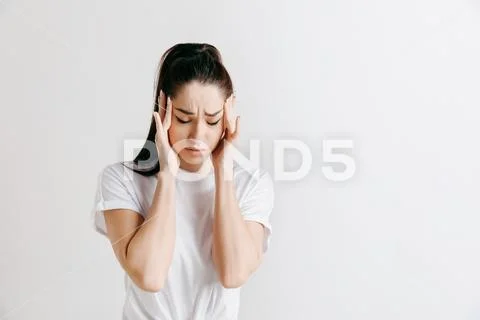 Woman having headache. Isolated over gray background. Stock Photos