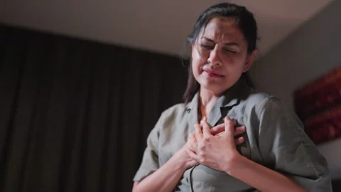 Woman having heart attack problems A heart attack occurs when an artery that sup Stock Footage 256974150