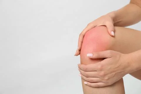 Woman having knee problems on grey background, closeup with space for text Stock Photos