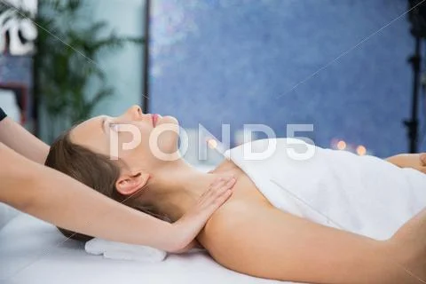Woman having neck massage in wellness center Stock Photos
