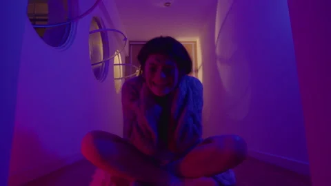 Woman Having Panic Attack and Screaming in Room with Neon Light Video stock 255314487